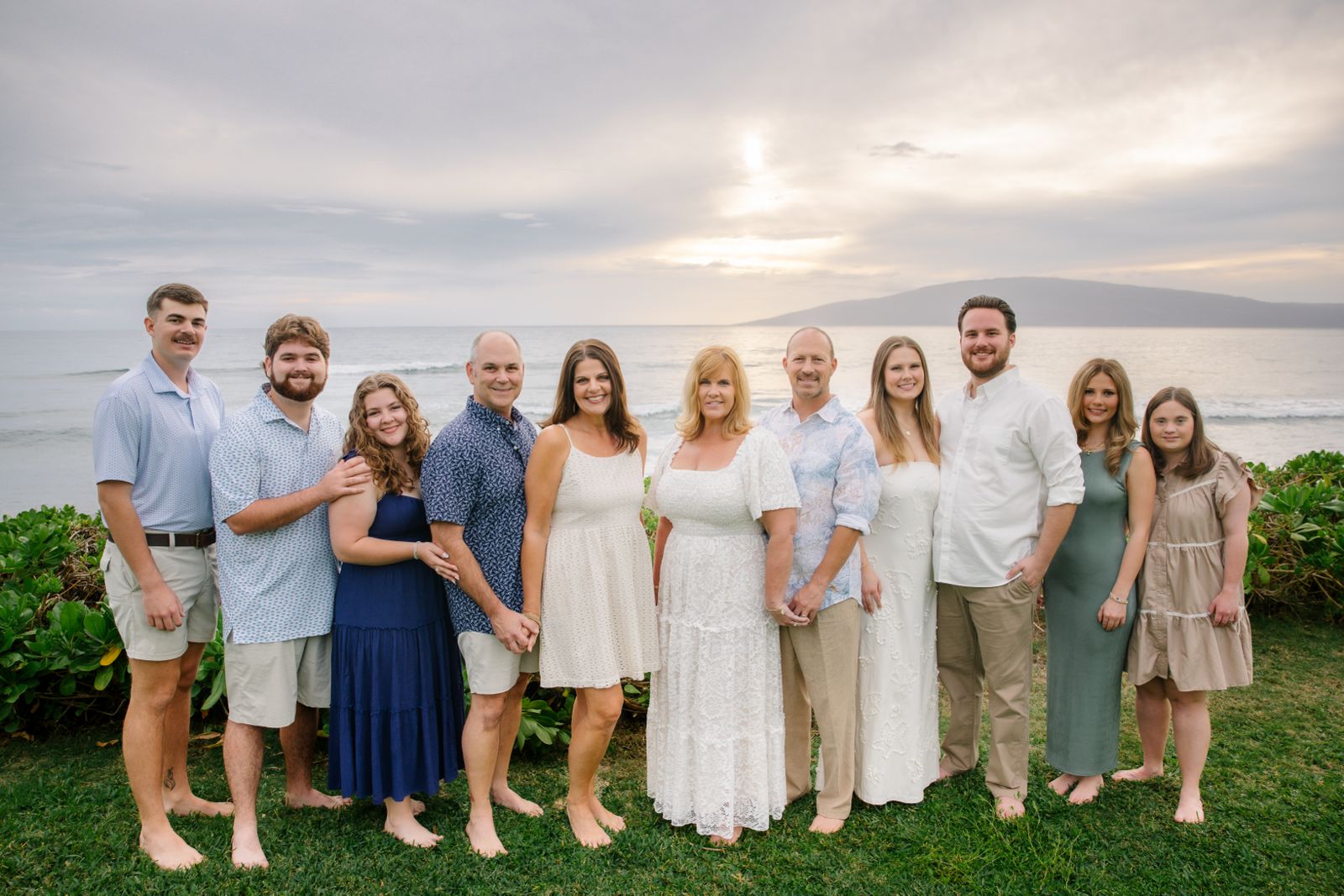 Large extended family at sunset by the ocean